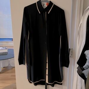 Navy blue shirt dress, with cream and light blue touches. Hangs above the knee.